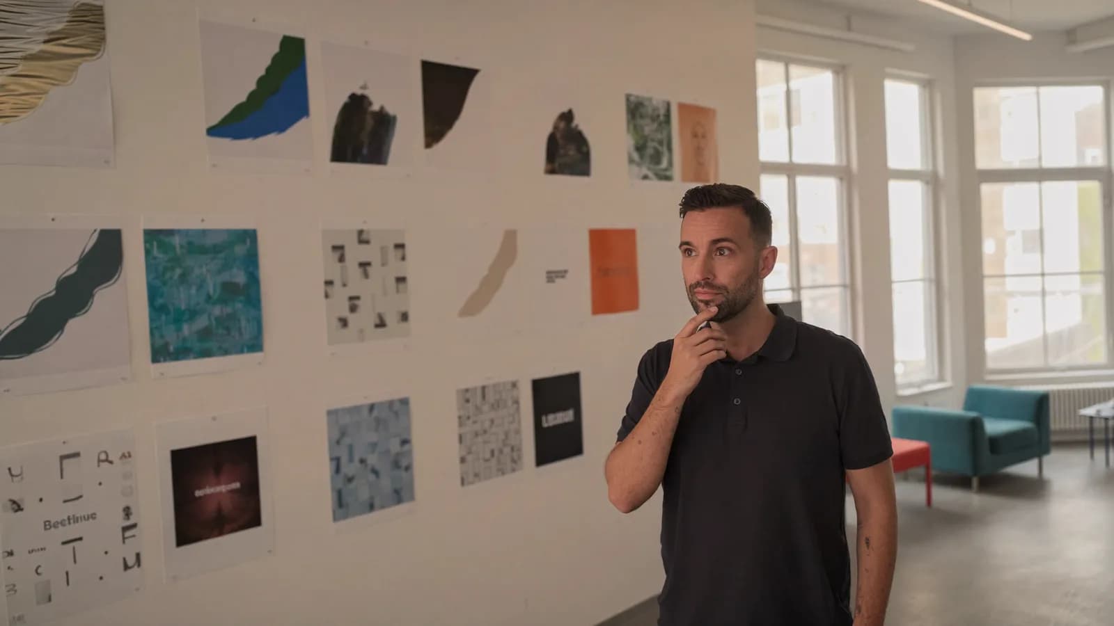 Torsten Schiefen studying a moodboard wall in a bright brand studio