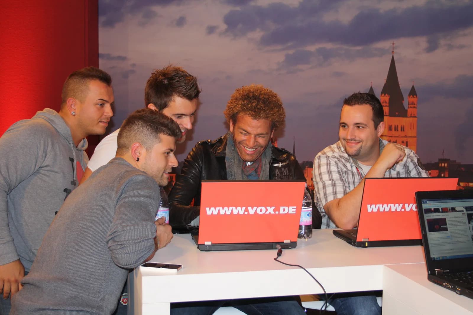Inside the first interactive backstage room of the VOX show X Factor: contestants at laptops
